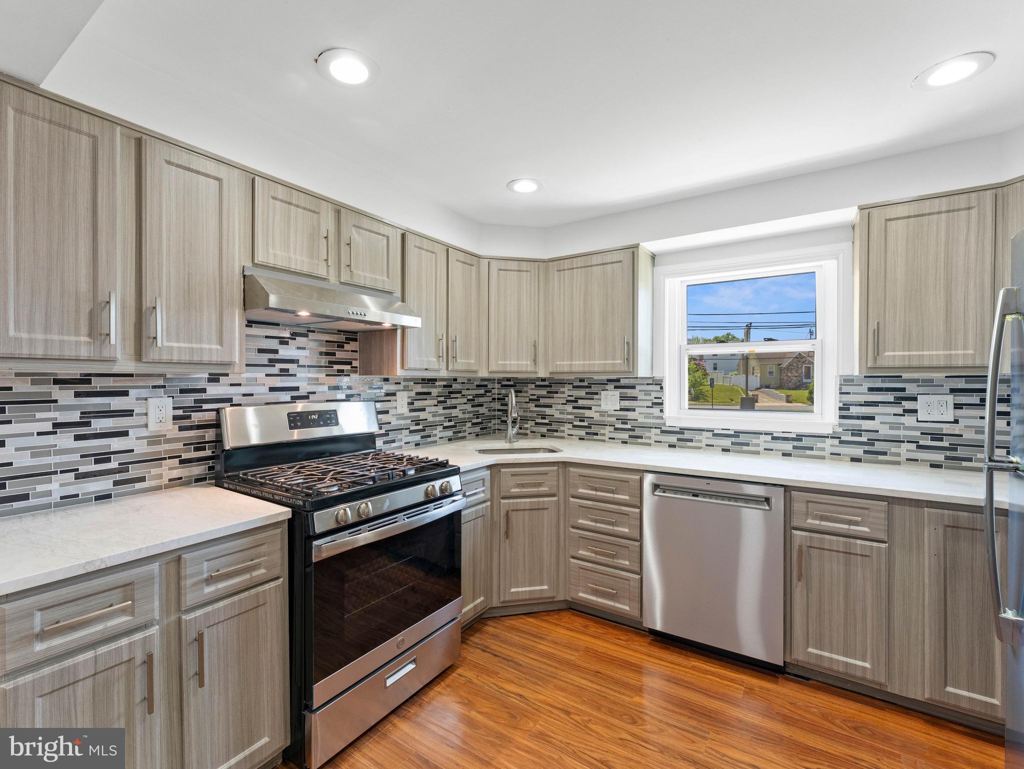 157 West Browning Road Bellmawr, NJ 08031 - Photo 10 of 41 a kitchen with stainless steel appliances granite countertop a stove sink and cabinets