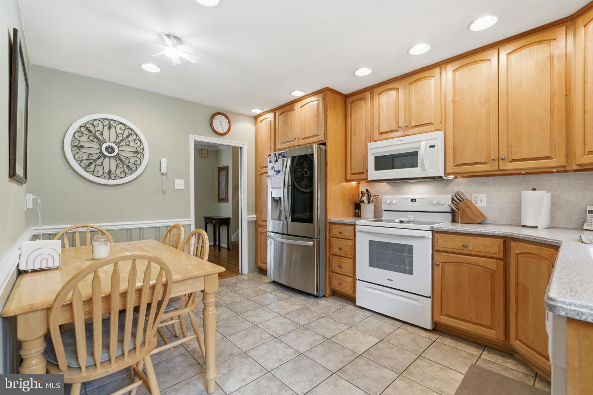 720 Evans Road Springfield, PA 19064 - Photo 11 of 38 a kitchen with a refrigerator and a stove top oven