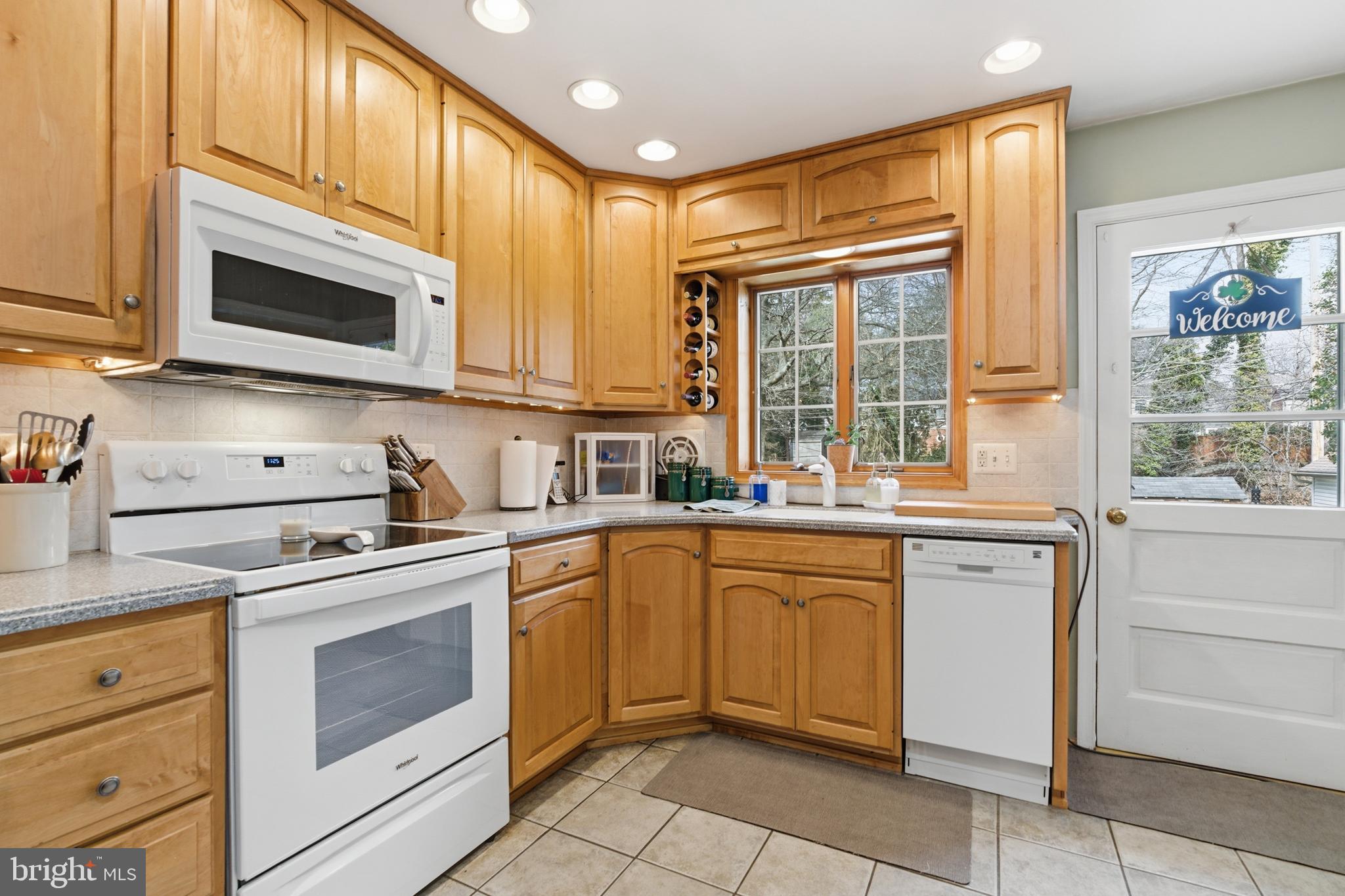 720 Evans Road Springfield, PA 19064 - Photo 12 of 38 a kitchen with granite countertop white cabinets stainless steel appliances and a sink