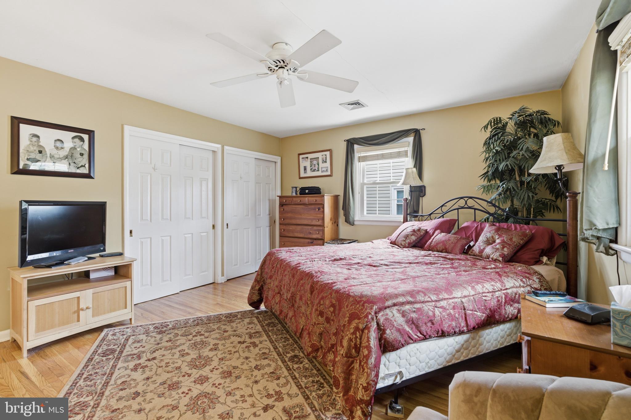 720 Evans Road Springfield, PA 19064 - Photo 15 of 38 a bedroom with a large bed and a flat screen tv