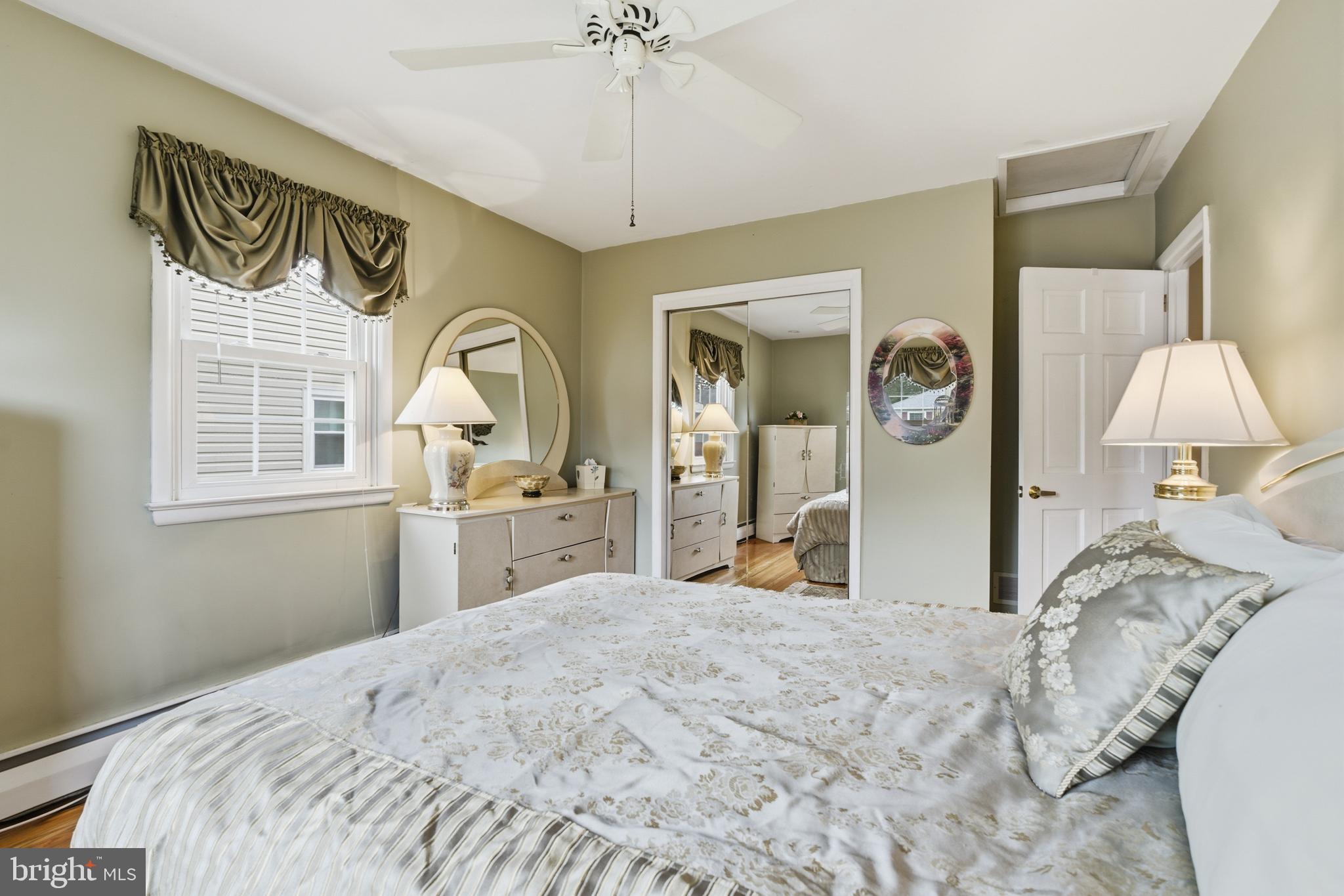 720 Evans Road Springfield, PA 19064 - Photo 19 of 38 a bedroom with a bed and a chandelier