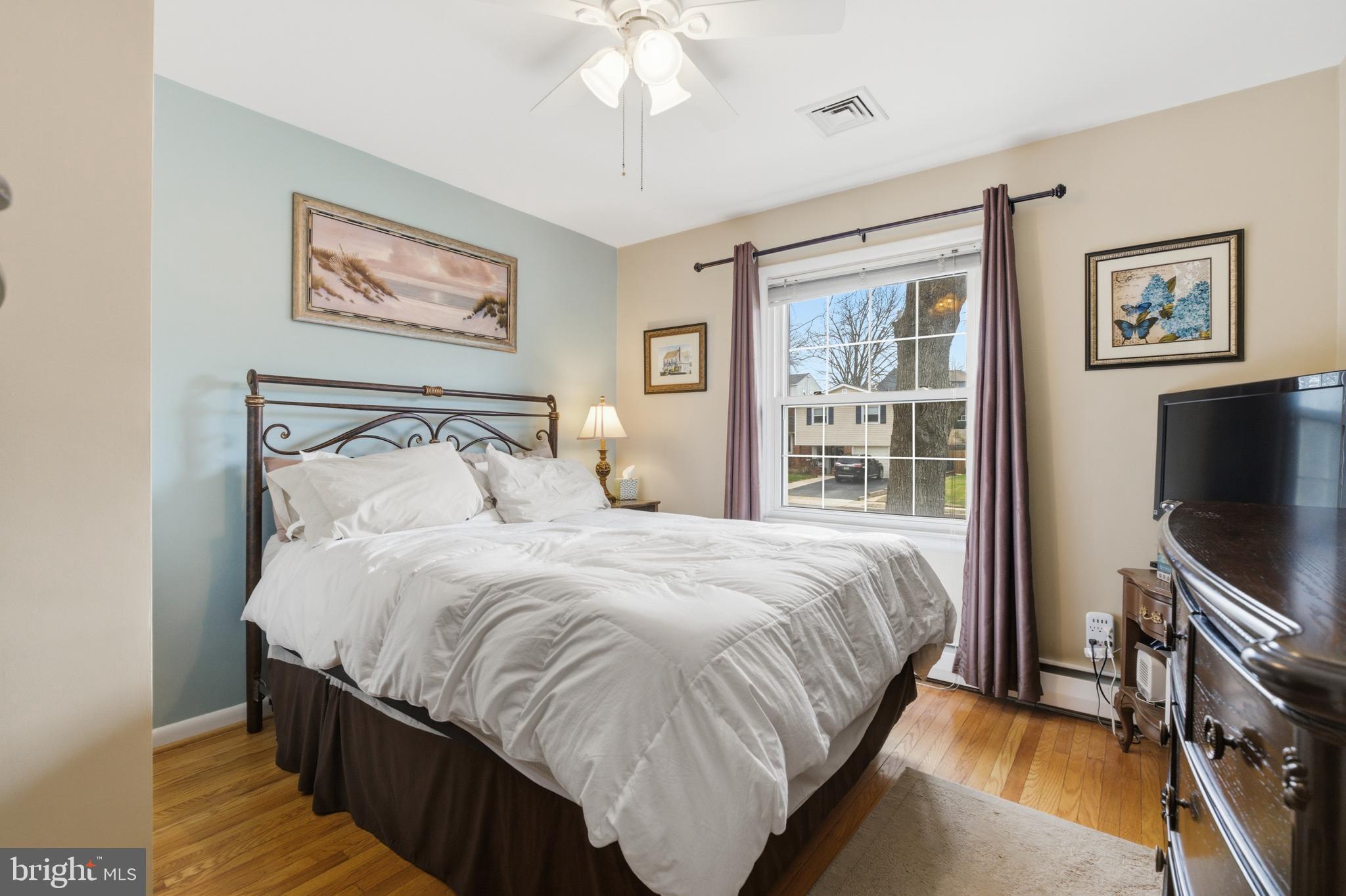 720 Evans Road Springfield, PA 19064 - Photo 20 of 38 a bedroom with bed tv and wooden floor