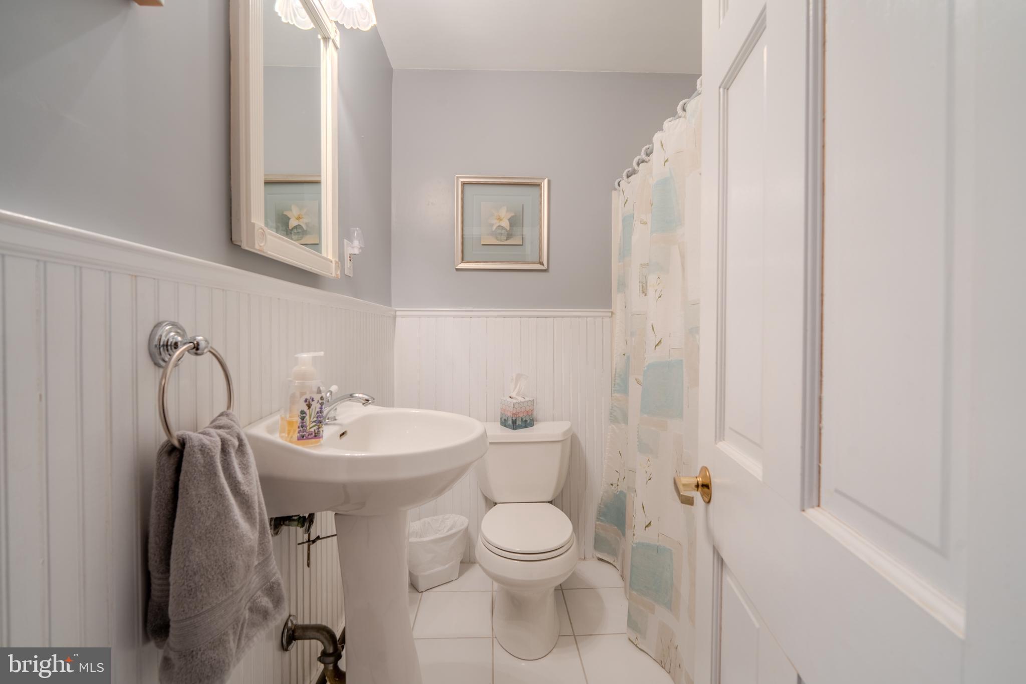 720 Evans Road Springfield, PA 19064 - Photo 21 of 38 a bathroom with a toilet sink and mirror