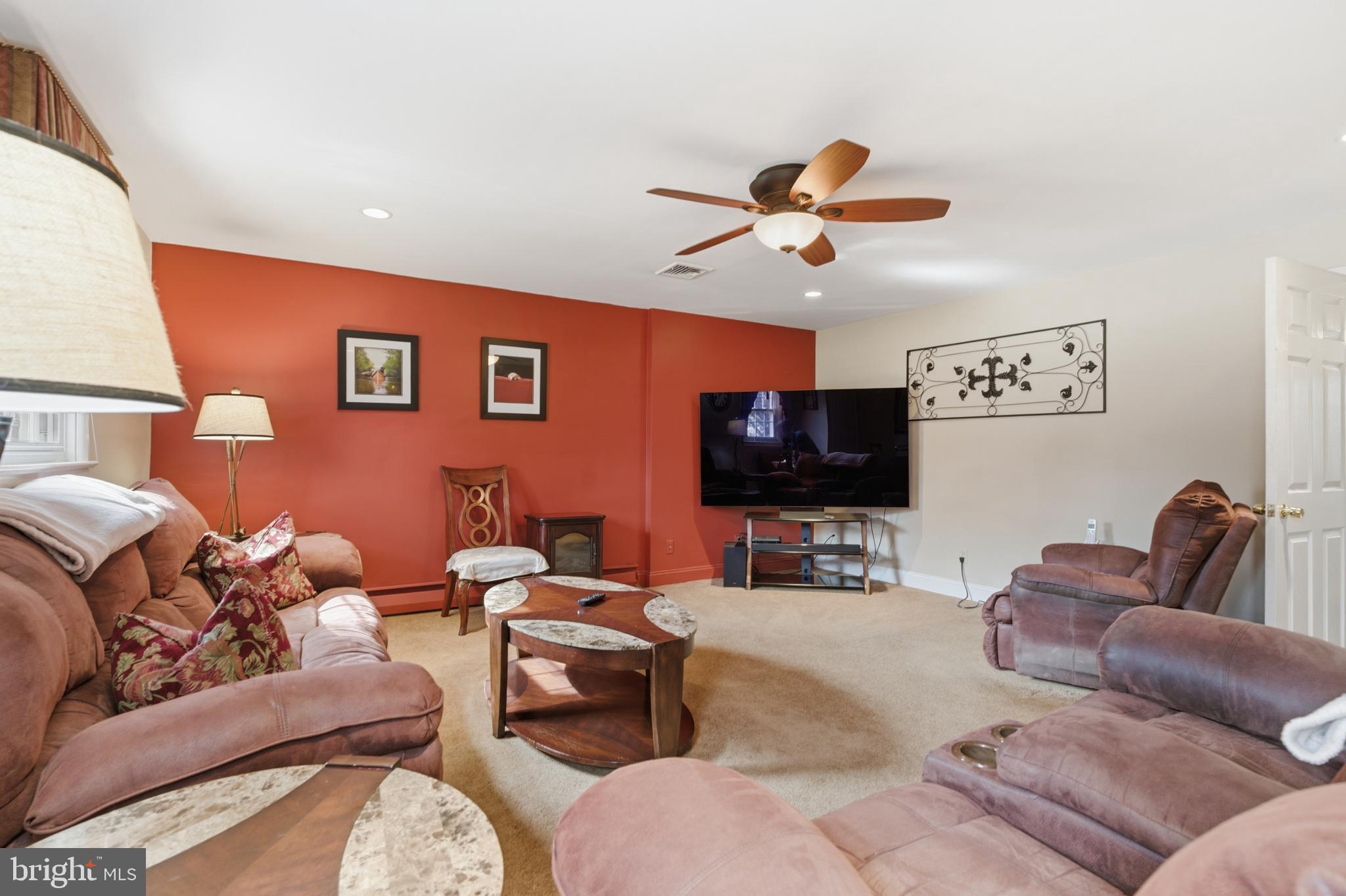 720 Evans Road Springfield, PA 19064 - Photo 26 of 38 a living room with furniture and a flat screen tv