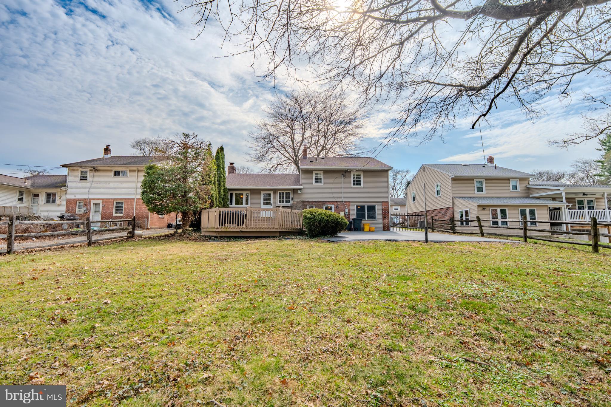 720 Evans Road Springfield, PA 19064 - Photo 31 of 38 a front view of a building with a garden and trees