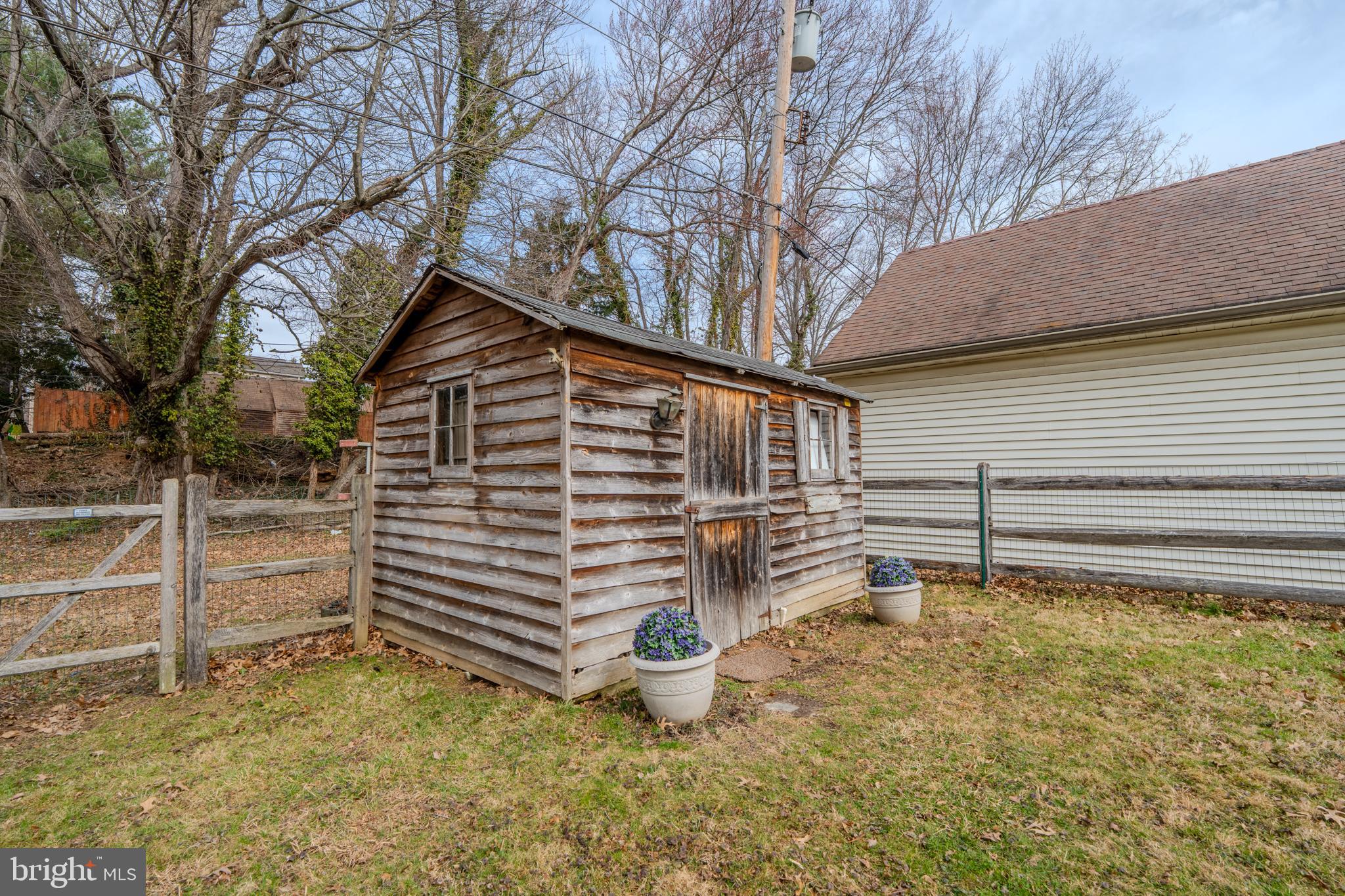 720 Evans Road Springfield, PA 19064 - Photo 36 of 38 a backyard of a house with barbeque oven and wooden fence
