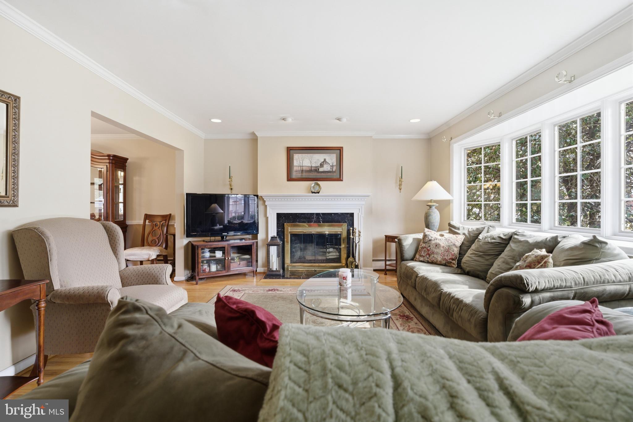 720 Evans Road Springfield, PA 19064 - Photo 6 of 38 a living room with furniture large window and a fireplace