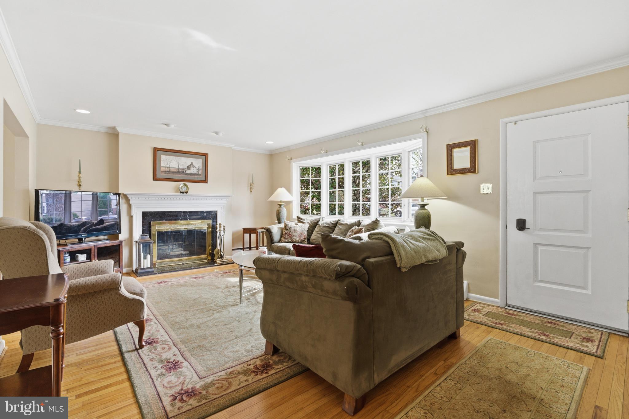 720 Evans Road Springfield, PA 19064 - Photo 7 of 38 a living room with furniture and a fireplace
