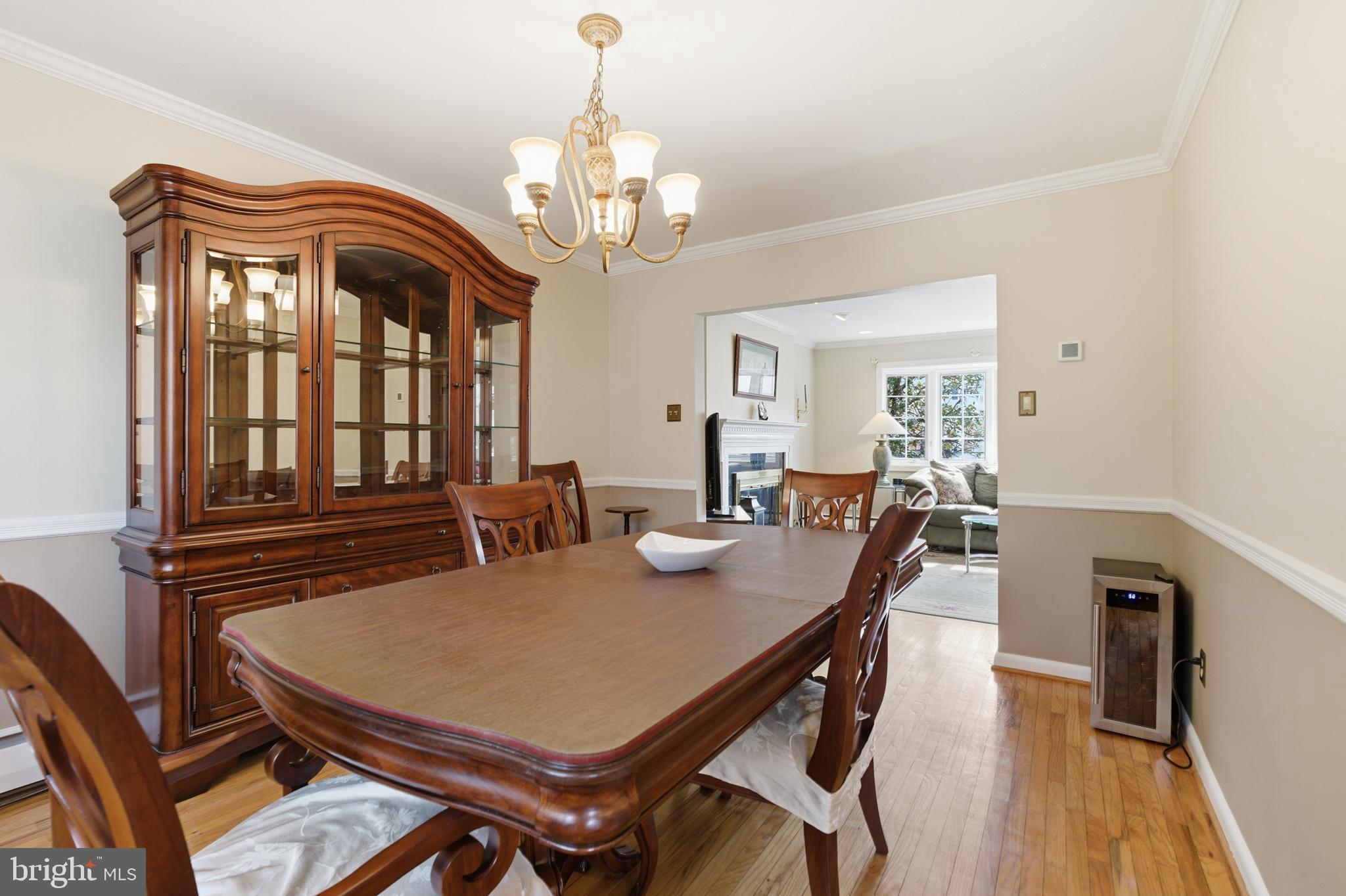 720 Evans Road Springfield, PA 19064 - Photo 10 of 38 a view of a dining room with furniture a chandelier and wooden floor