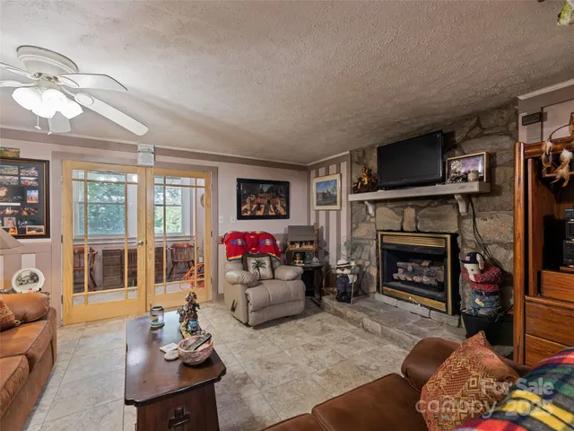 a living room with furniture a flat screen tv and a fireplace