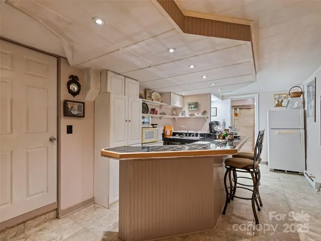 a kitchen with stainless steel appliances a refrigerator a stove a sink dishwasher and a refrigerator with wooden floor