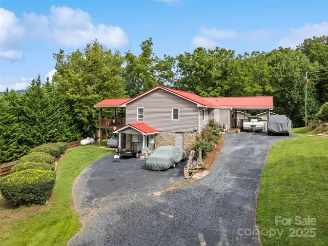 a view of an house with backyard space and sitting area