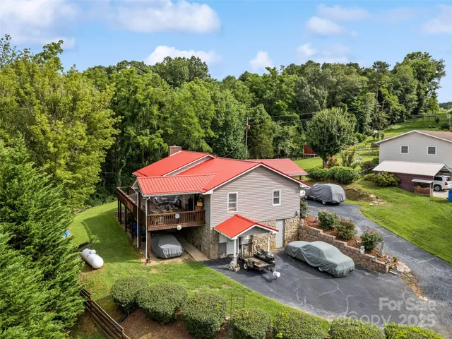 an aerial view of a house with swimming pool and garden