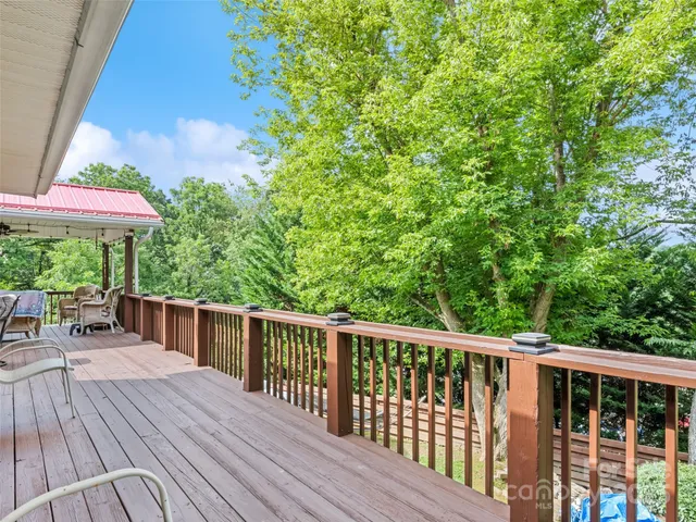a view of a wooden deck with a yard