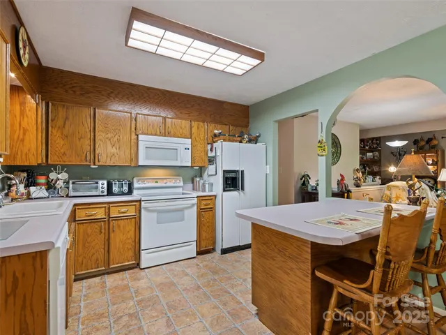 a kitchen with a stove a refrigerator and a sink
