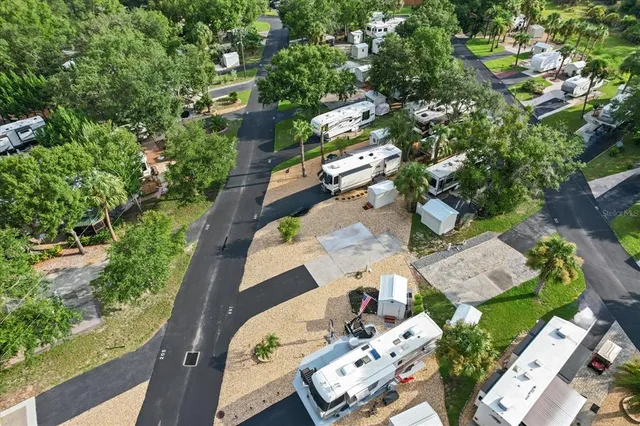 an aerial view of a house with garden space and street view