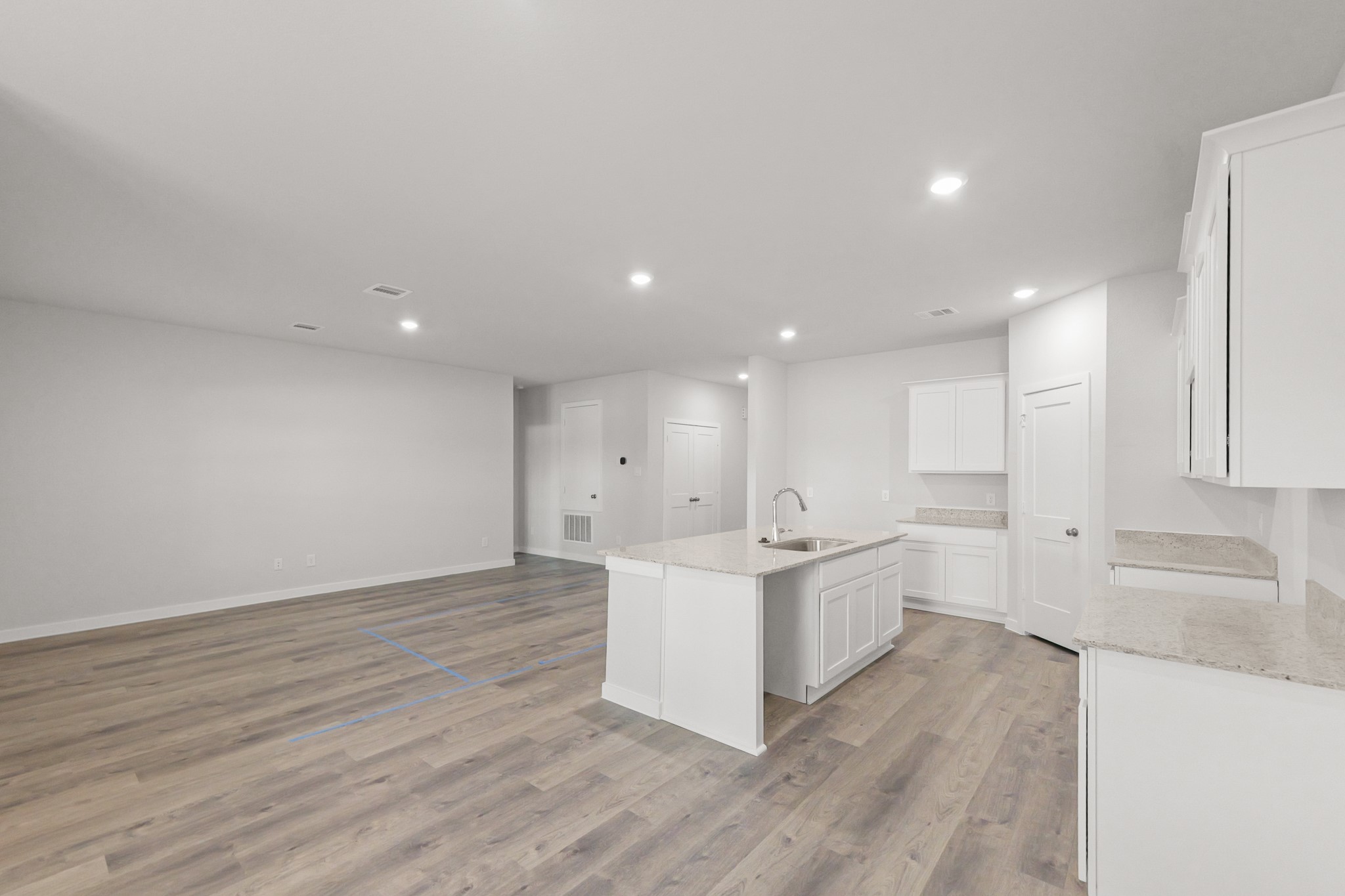 469 Shoreview Drive Conroe, TX 77303 - Photo 20 of 41 a large white kitchen with wooden floors and white cabinets