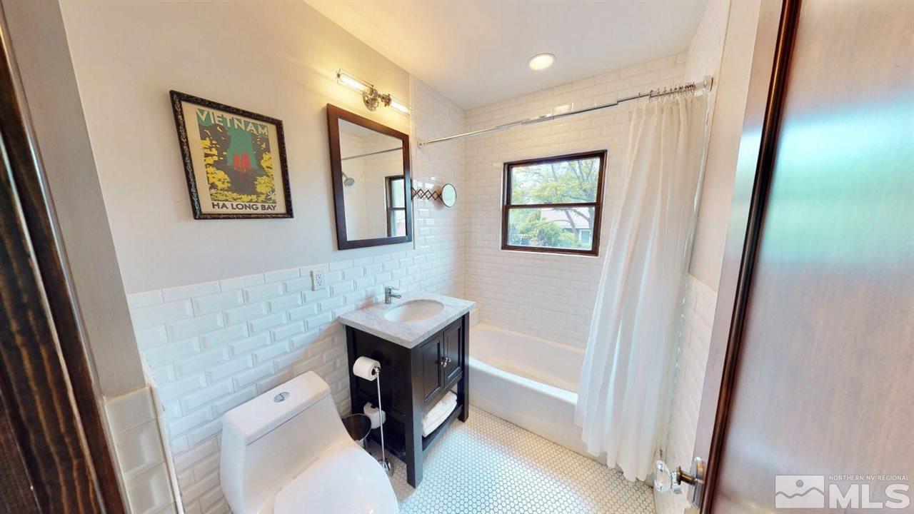 1300 Clough Road Reno, NV 89509 - Photo 14 of 40 a bathroom with a sink and a mirror