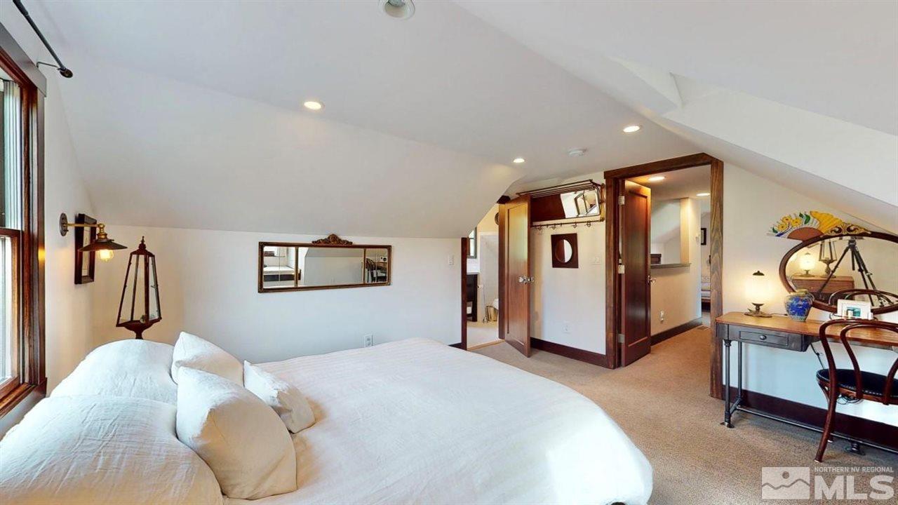 1300 Clough Road Reno, NV 89509 - Photo 21 of 40 a bedroom with a bed and dresser with mirror