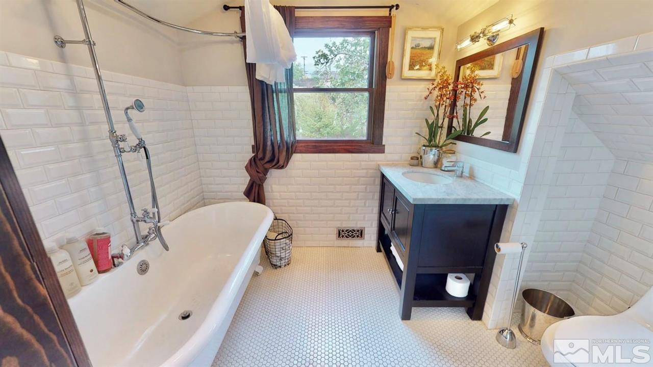 1300 Clough Road Reno, NV 89509 - Photo 24 of 40 a bathroom with a tub sink and mirror