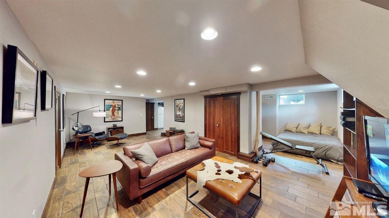 1300 Clough Road Reno, NV 89509 - Photo 28 of 40 a living room with furniture a flat screen tv and a mirror