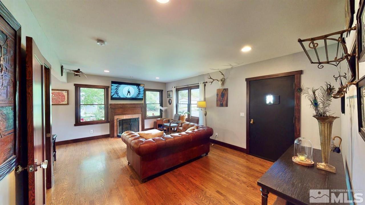1300 Clough Road Reno, NV 89509 - Photo 3 of 40 a living room with furniture a fireplace and a flat screen tv