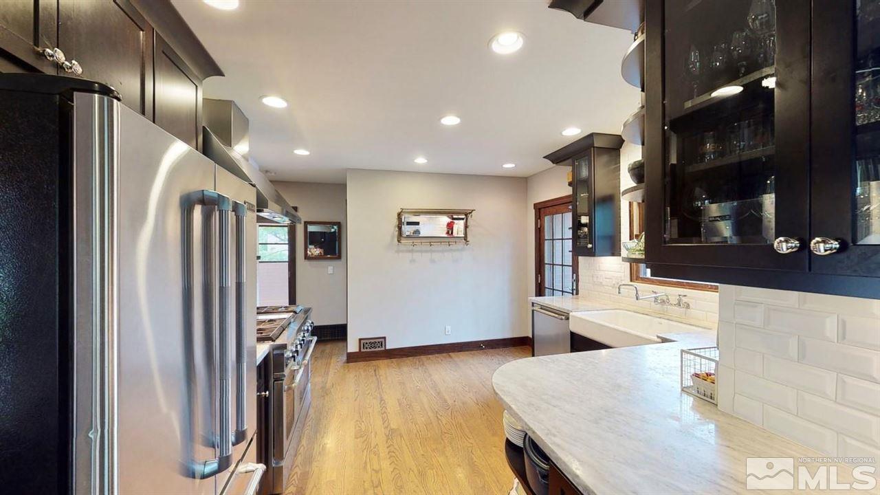 1300 Clough Road Reno, NV 89509 - Photo 8 of 40 an open kitchen with stainless steel appliances granite countertop a refrigerator and a stove