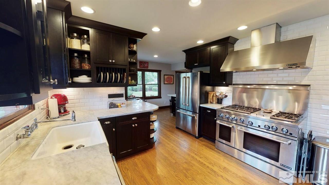 1300 Clough Road Reno, NV 89509 - Photo 10 of 40 a kitchen with stainless steel appliances granite countertop a stove and a sink