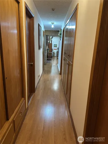 a view of hallway with wooden floor
