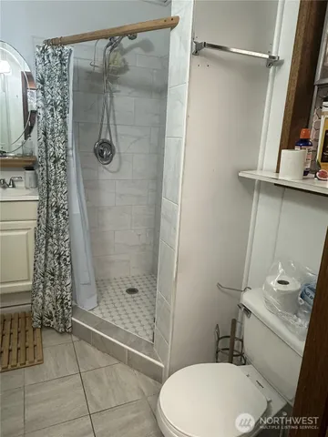 a bathroom with a toilet and a shower