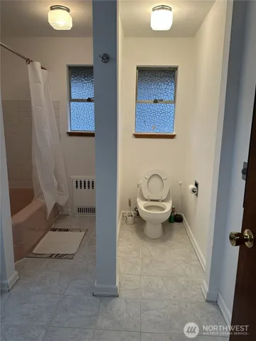a bathroom with a toilet sink and shower