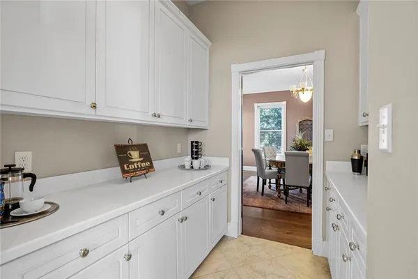 a kitchen with cabinets stainless steel appliances a sink and wooden floor