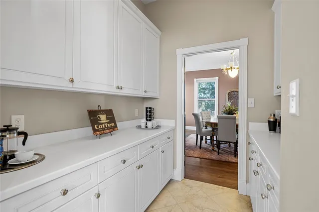 a kitchen with cabinets stainless steel appliances a sink and wooden floor
