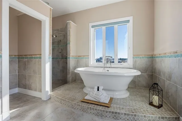 a view of an empty room with a fireplace and a window