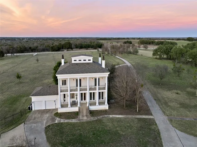 a view of a house with a yard and a fountain