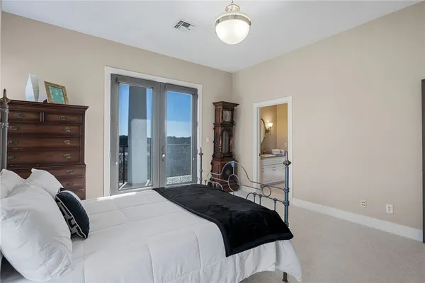 a bedroom with a bed and a lamp