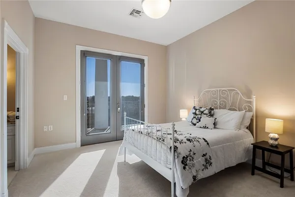 a en suite bathroom with a granite countertop sink and a mirror