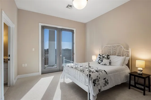 a en suite bathroom with a granite countertop sink and a mirror