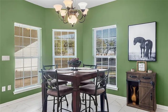 a kitchen with white cabinets and refrigerator