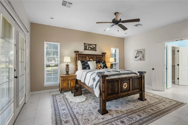 a bathroom with a bathtub a sink and mirror