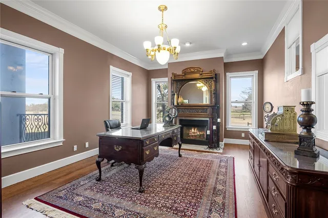 a living room with fireplace furniture and a chandelier