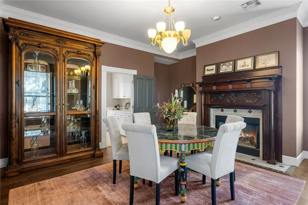 a view of a dining room with furniture and a chandelier