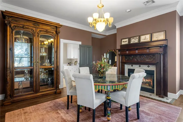 a view of a dining room with furniture and a chandelier