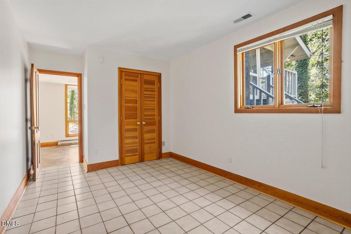 4805 Rembert Drive Raleigh, NC 27612 - Photo 34 of 45 a view of an empty room with wooden floor