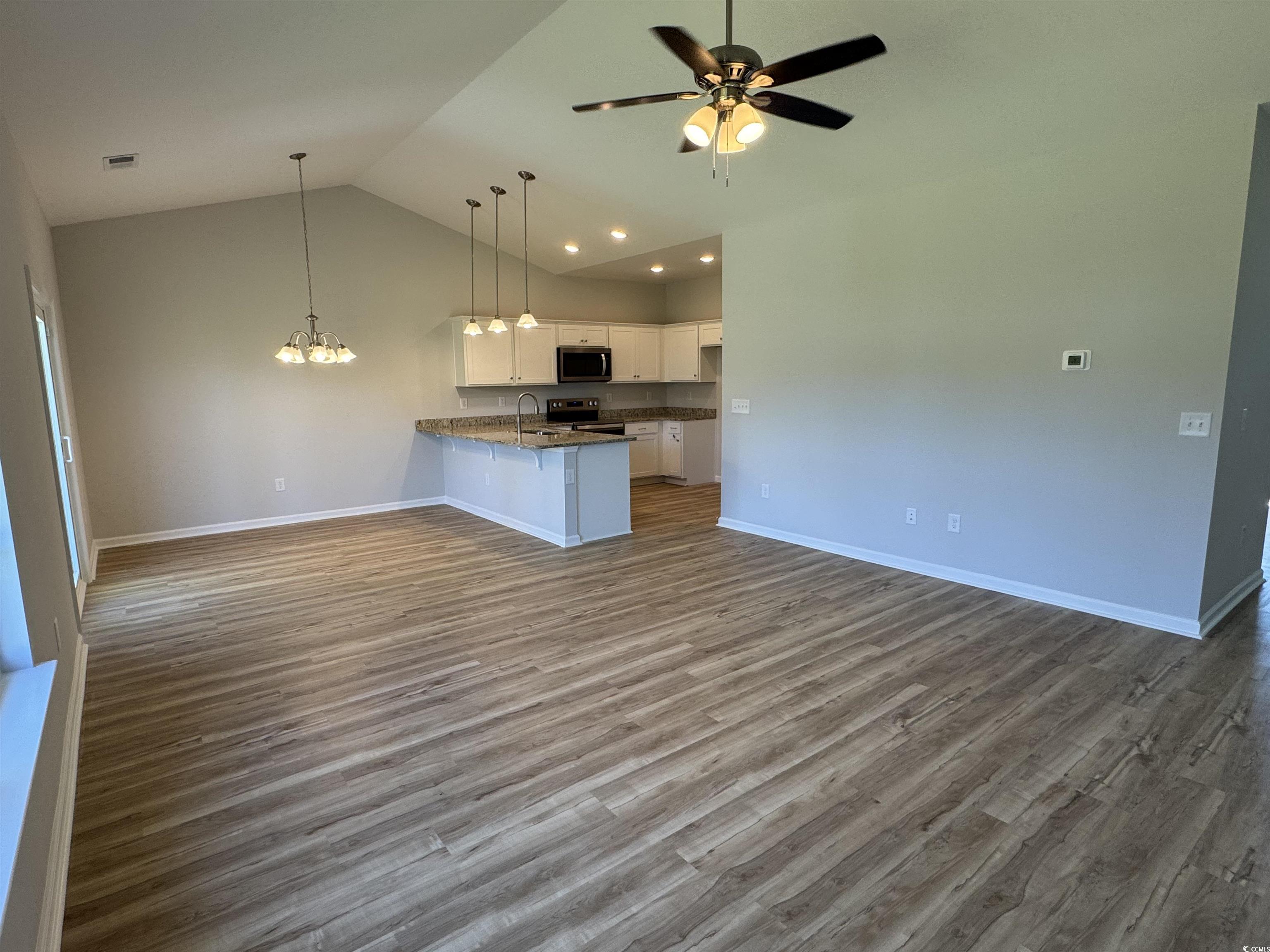 596 Shallow Cv Drive Conway, SC 29527 - Photo 25 of 25 Kitchen with white cabinetry, open floor plan, dar