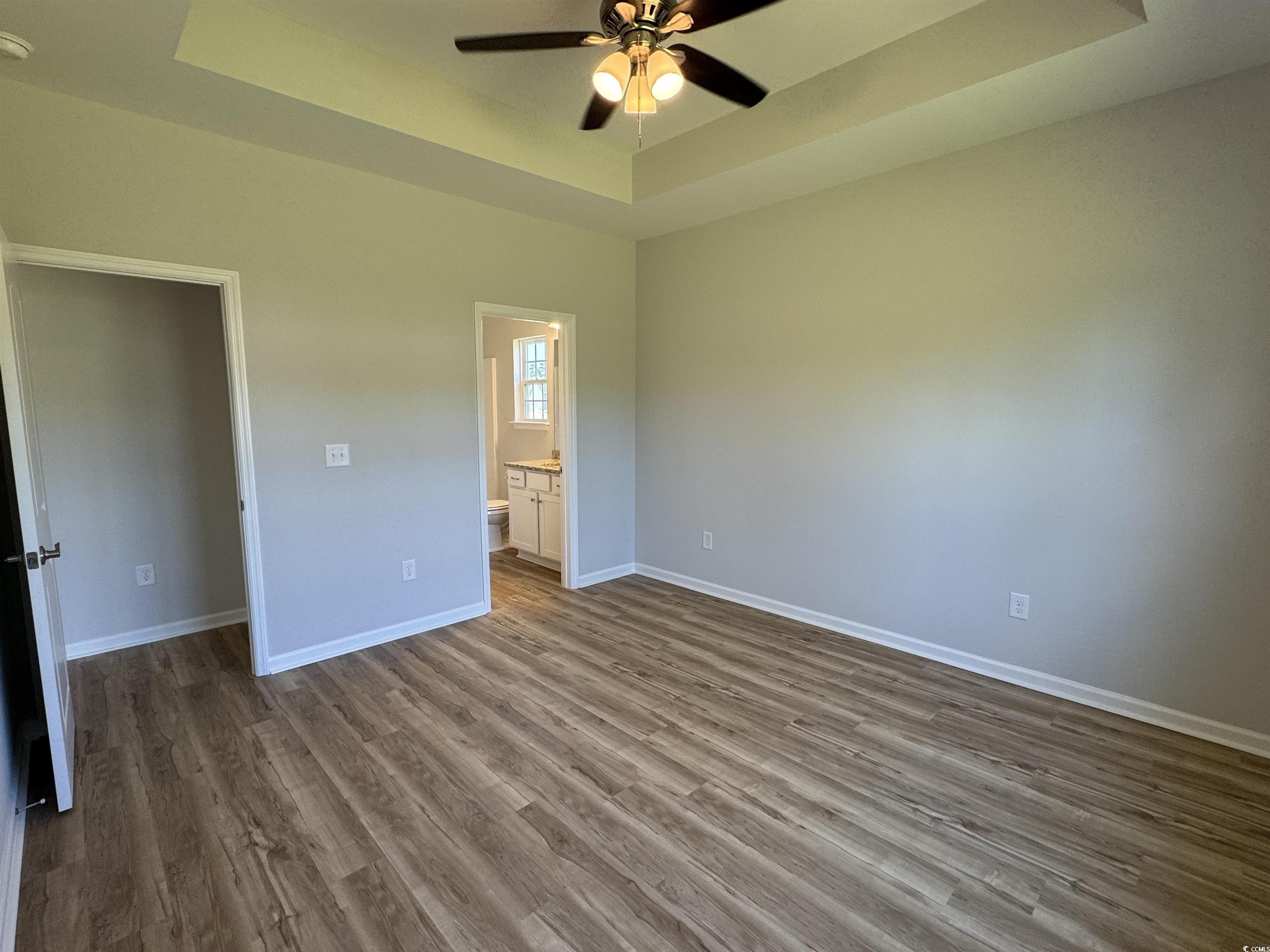596 Shallow Cv Drive Conway, SC 29527 - Photo 3 of 25 Unfurnished bedroom with a raised ceiling, dark wo