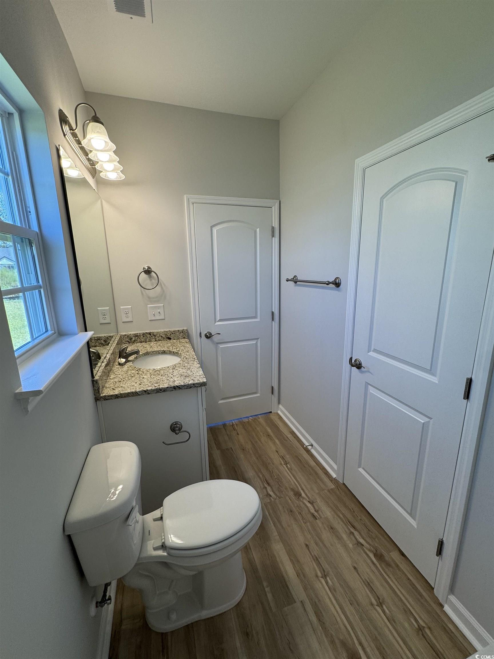 596 Shallow Cv Drive Conway, SC 29527 - Photo 8 of 25 Half bathroom with vanity and dark wood-style floo