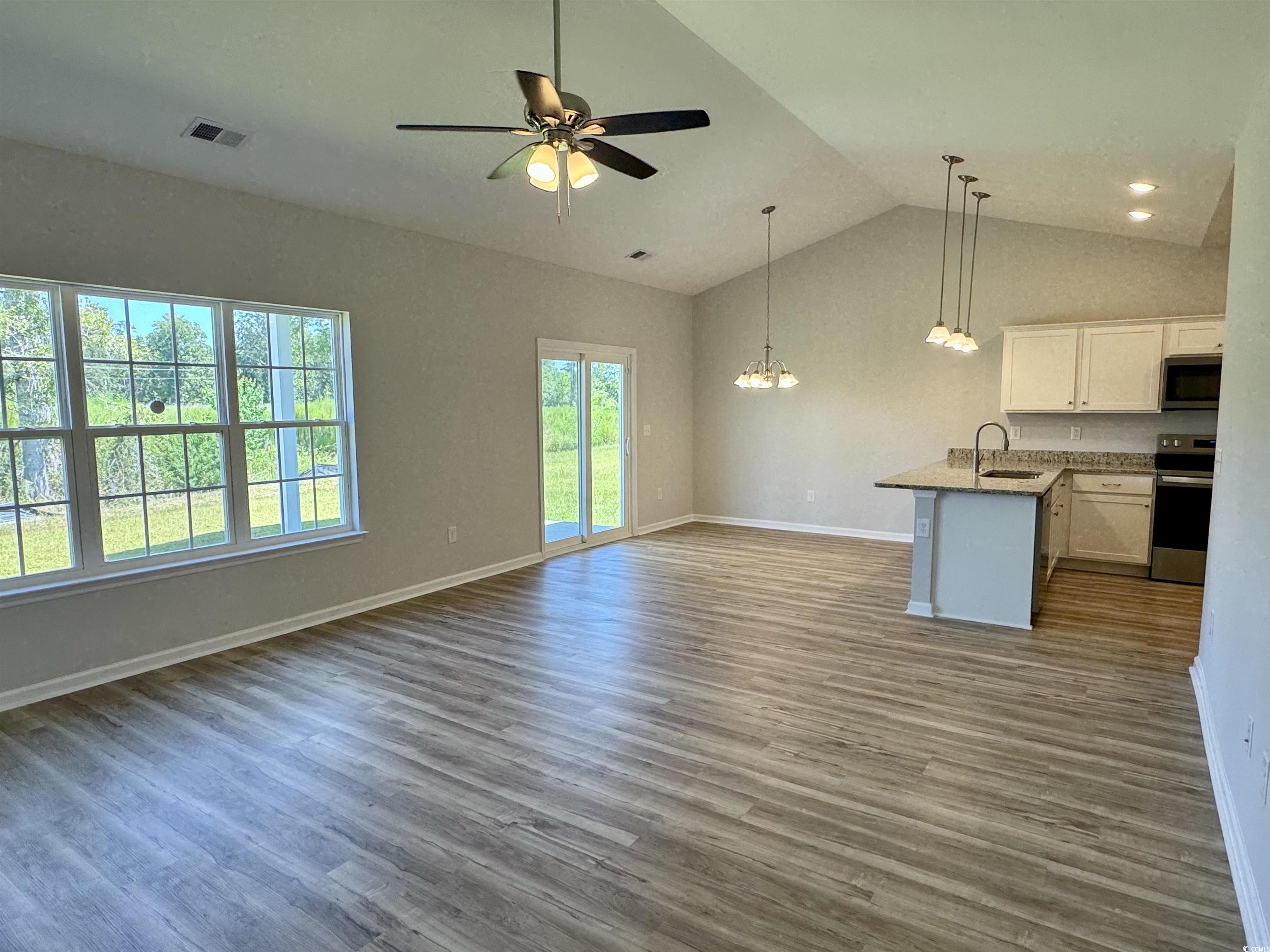 596 Shallow Cv Drive Conway, SC 29527 - Photo 10 of 25 Unfurnished living room with dark wood-type floori