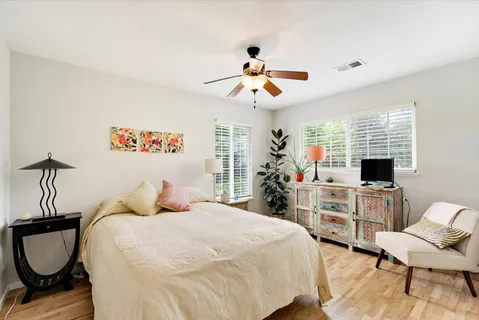 a bedroom with a bed and a chandelier