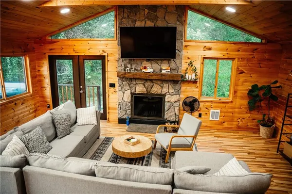 a living room with furniture a fireplace and a flat screen tv